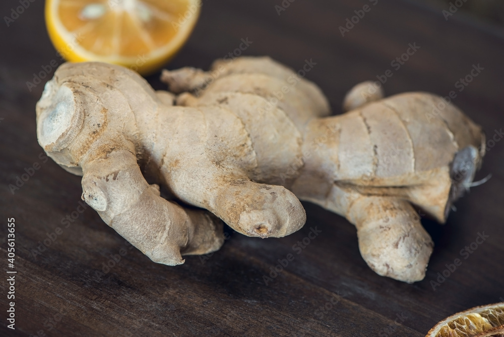 Fototapeta premium Organic ginger root and lemon on a wooden table, close up, macro photography