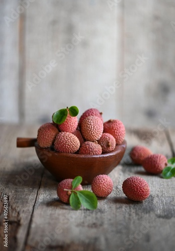 Fresh red lychee fruits.  Fresh organic lychee fruit on a rustic wooden background.