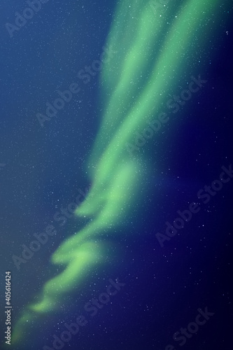 Night starry sky and Northern lights. Green aurora borealis