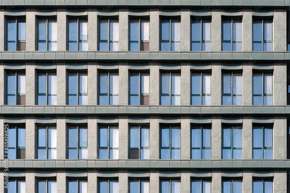 Fragment of common building facade with windows reflecting the sky Fragment of common building facade with windows reflecting the sky