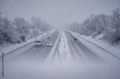Vehicles on the highway in the snowstorm.