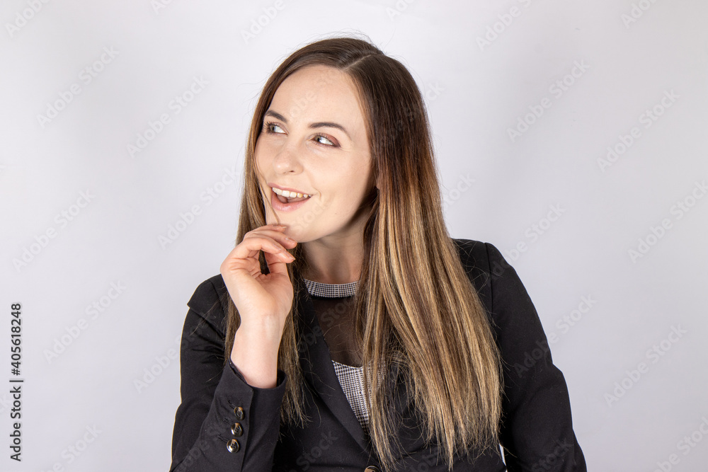 An attractive business woman wearing a business suit on a plain background An attractive business woman wearing a business suit on a plain background