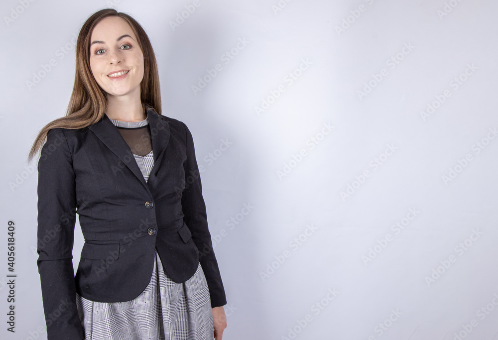 An attractive business woman wearing a business suit on a plain background An attractive business woman wearing a business suit on a plain background