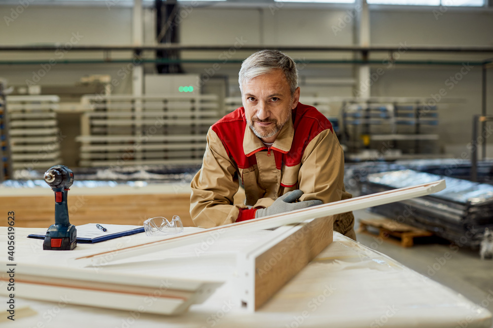 Portrait of mid adult carpenter at his workshop. Portrait of mid adult carpenter at his workshop.