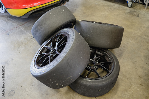 Four slick racing tires behind a race car.