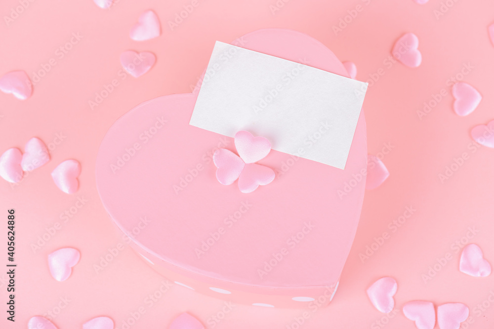 Pink heart shape gift box with card on a pink backround, Celebration Valentine's day, holiday, anniversary of married couple, birthday background
