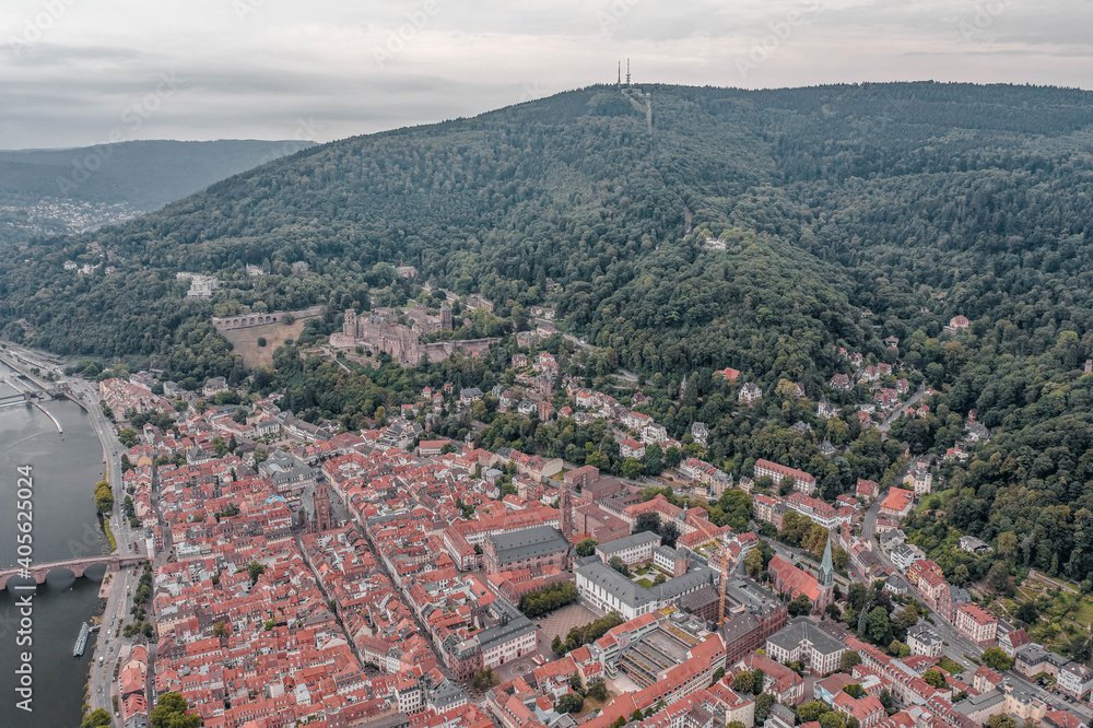 Aerial drone shot of Heidelberg old town in overcast at foot of Konigstuhl mountain