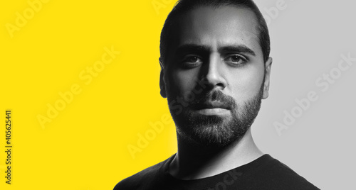 Black and white portrait of Middle eastern guy looking at the camera isolated on white background