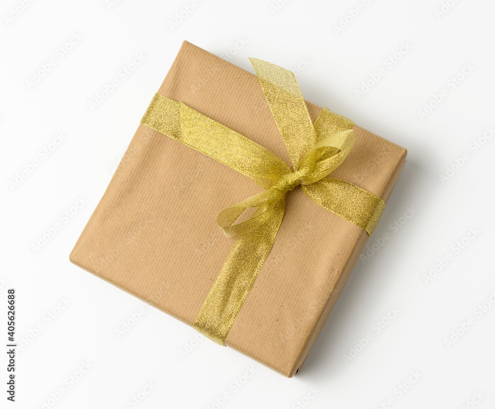 box wrapped in brown kraft paper and tied with golen ribbon box wrapped in brown kraft paper and tied with golen ribbon