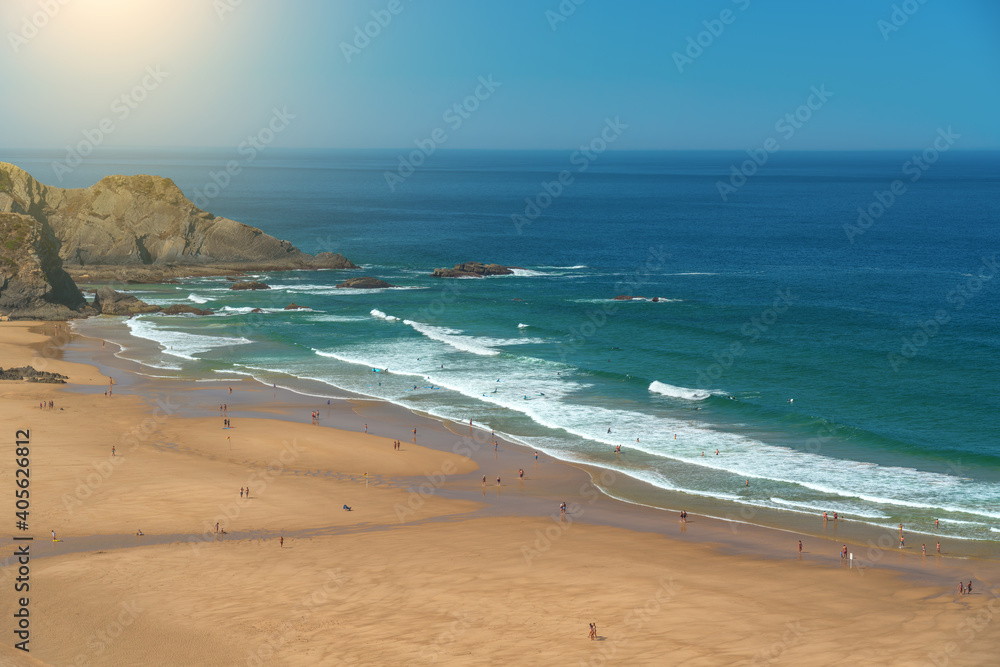Delightful panoramic view of the Portuguese beach Odeceixe with tourists at the sea.