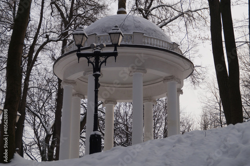 White gazebo in a snow-covered park photo