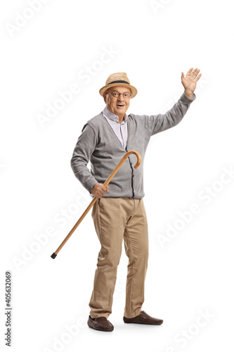 Elderly man holding a cane and waving