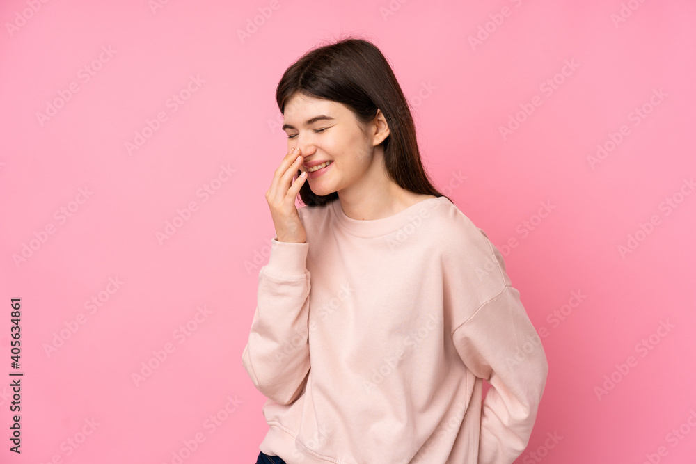 Young Ukrainian teenager girl over isolated pink background smiling a lot