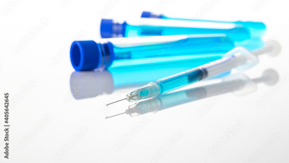 Medical needles. Medical syringe with needle for protection flu virus and coronavirus. Covid vaccine on white. Nurse or doctor. Liquid drug or narcotic. Medical needles. Medical syringe with needle for protection flu virus and coronavirus. Covid vaccine on white. Nurse or doctor. Liquid drug or narcotic.