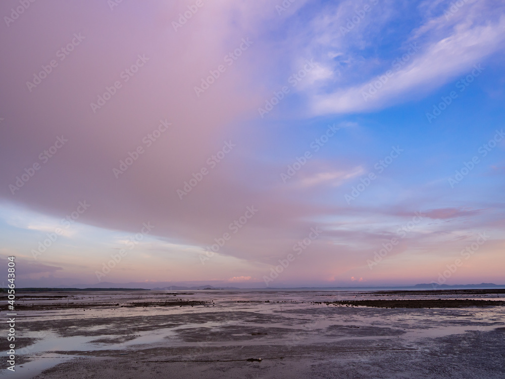 abstract color of the pinky sky and cloudy dark clouds in dawn time, sunrise morning over seacoast. skies covered colourful cirrus clouds moving forward to rocky shore. beautiful nature seascape. abstract color of the pinky sky and cloudy dark clouds in dawn time, sunrise morning over seacoast. skies covered colourful cirrus clouds moving forward to rocky shore. beautiful nature seascape.