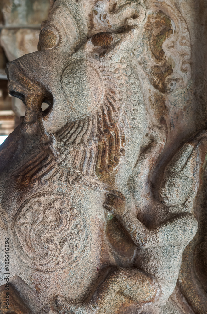 Hampi, Karnataka, India - November 5, 2013: Vijaya Vitthala Temple. closeup of gray stone rider on Narasimha statue as part of pillar in main Mandapam.