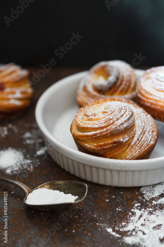 Jast baked cruffins on a white plate, food background