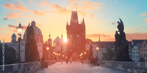 Charles Bridge at dawn: silhouettes of Old Bridge Tower, churches and spires of Old Prague on a sunrise, panoramic image.