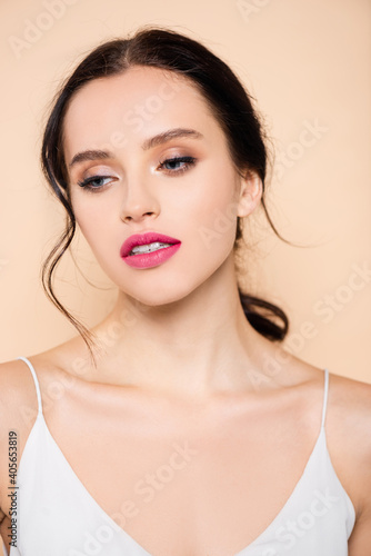 sensual young woman looking away isolated on pink