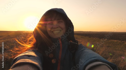 Happy smiling girl walks at sunset and laughs. It's fun to travel together. Camping life. Look for adventure travel. Love for nature and life. Enjoy and breathe fresh air. Evening sports walks in the