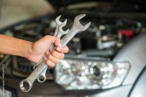 Hand holding wrench. Auto repair shop service.