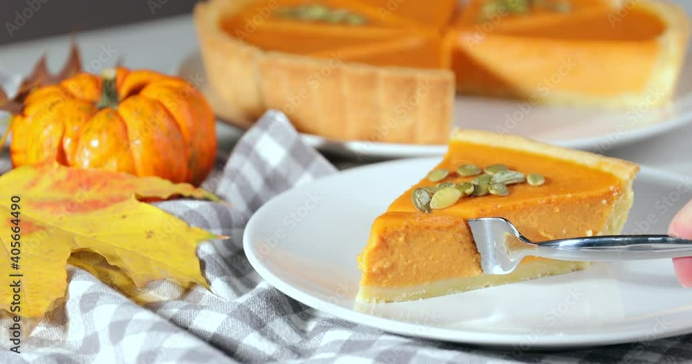 Eating of tasty pumpkin pie at table Eating of tasty pumpkin pie at table