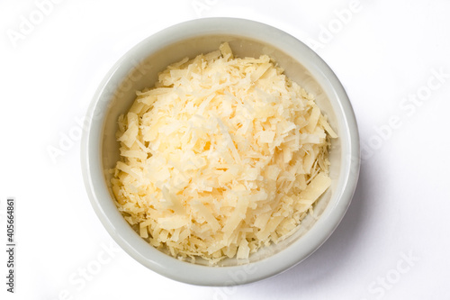 Top view of small ceramic pot with grated cheese. Isolated on white background