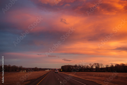 Beautiful sky at sunset dark blue and bright orange clouds over the highway