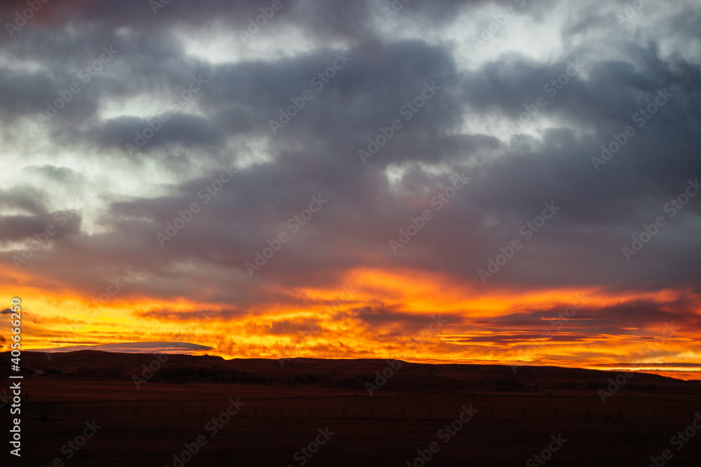 Fiery scenic sunset sky in blue and bright orange colors