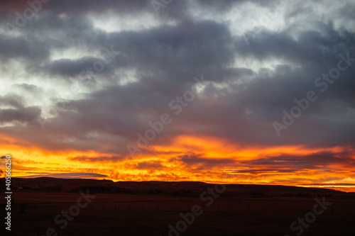 Fiery scenic sunset sky in blue and bright orange colors © Liudmila
