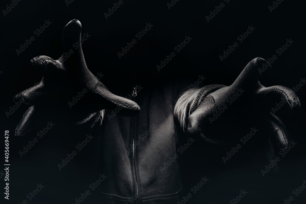 Horror photo of a scary man hands reaching out from darkness with fog.