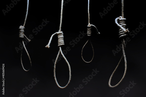 Horror photo of a dark scary hanging nooses on black background. photo