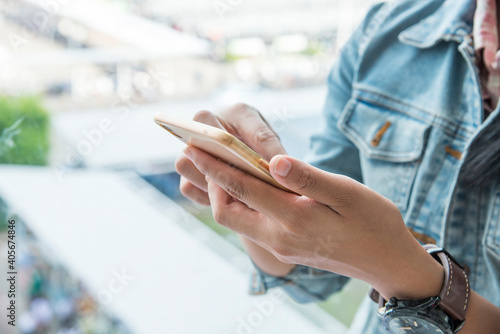 Woman sending message on smartphone  touching smartphone screen