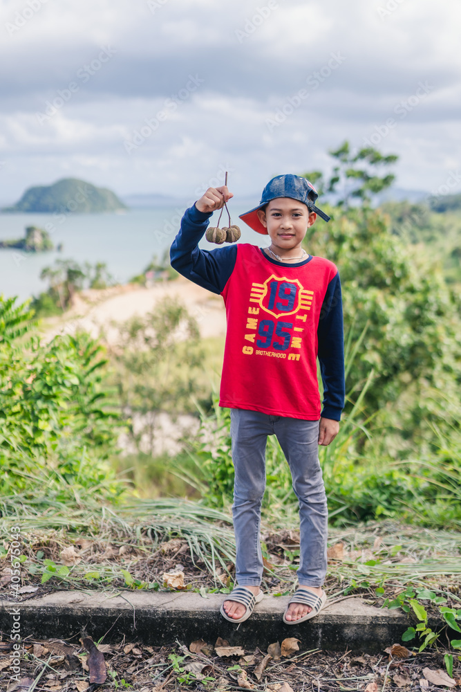 Fototapeta premium The boy is traveling near the beach