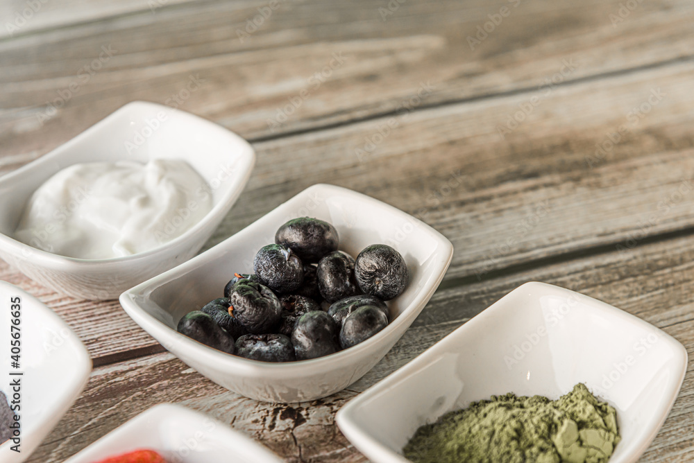 Raspberries, yoghurt, and healthy ingredients in wooden background Raspberries, yoghurt, and healthy ingredients in wooden background