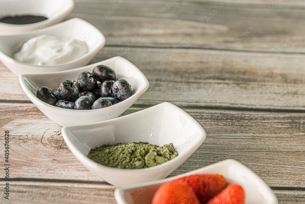 Raspberries, yoghurt, and healthy ingredients in wooden background Raspberries, yoghurt, and healthy ingredients in wooden background