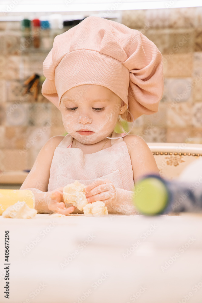 Little girl cooks at home in the kitchen Little girl cooks at home in the kitchen