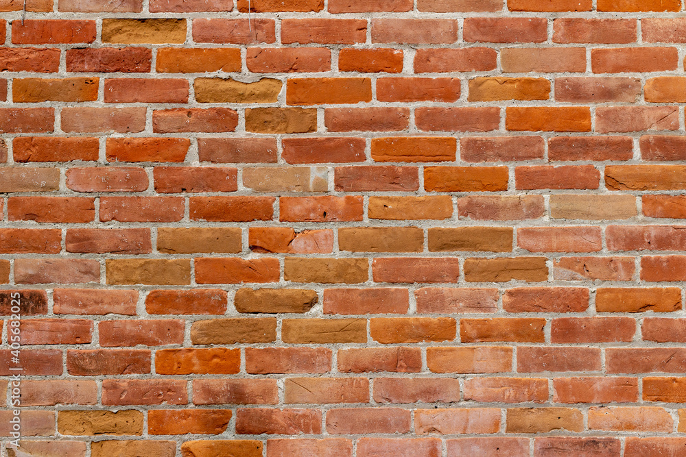 Obraz premium Full frame texture background of a 19th century traditional red clay brick wall with normal aging and weathering from age, with copy space