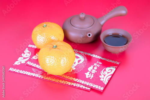 Tea set and red packets and oranges