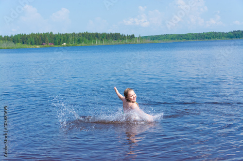 A girl plays in the water on a hot sunny day. 