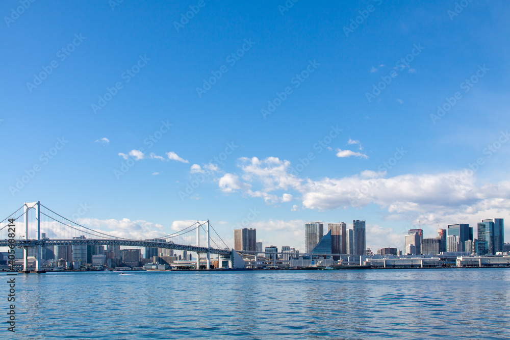 Tokyo cityscape with the rainbow bridge against the blue sky