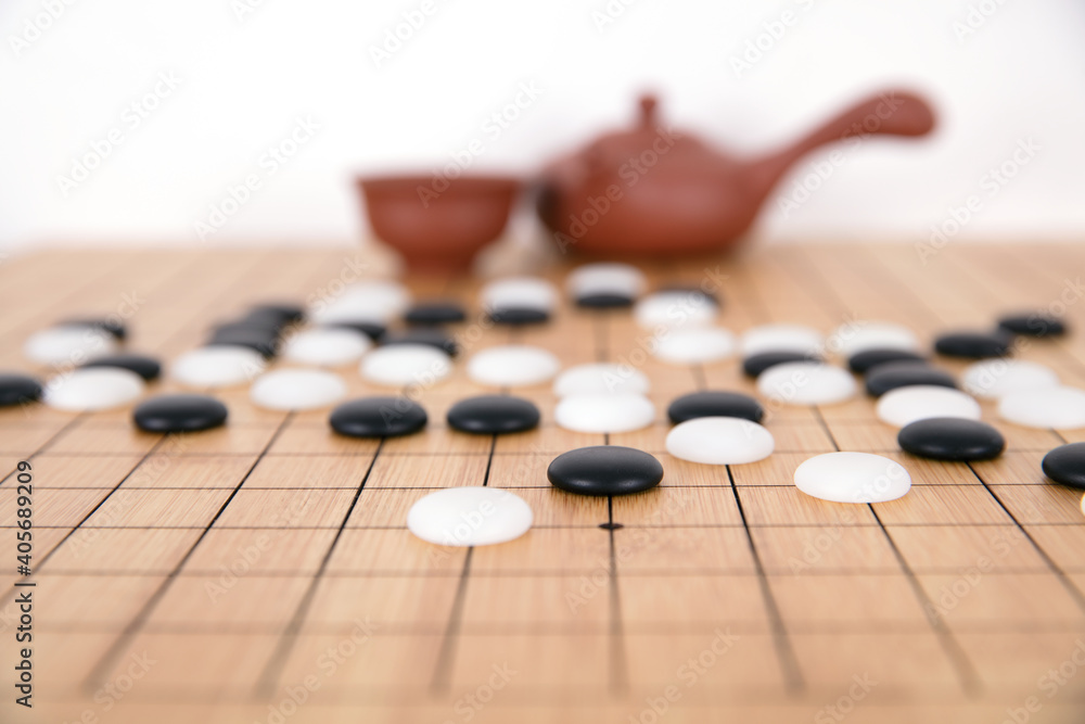 Chess pieces and tea set background on chess board Chess pieces and tea set background on chess board