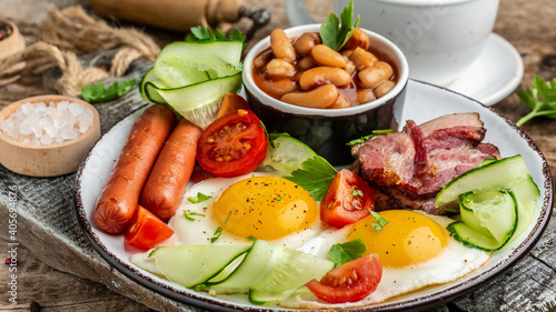 English breakfast with sausage, eggs and beans, Delicious breakfast or snack, Food recipe background. Close up