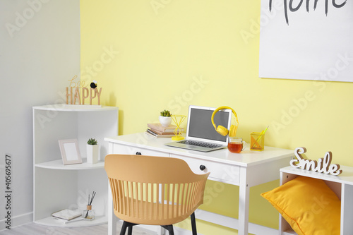 Stylish interior of workplace with modern gadgets at home