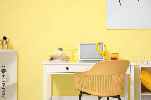 Stylish workplace with modern gadgets in room © Pixel-Shot