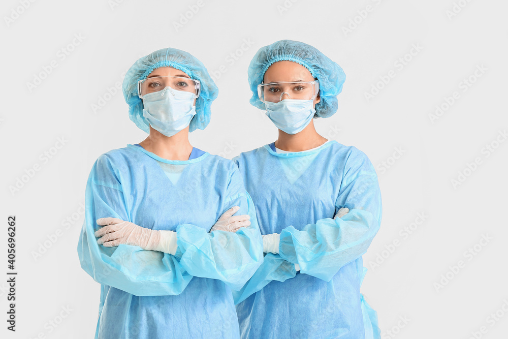 Portrait of female surgeons on light background Portrait of female surgeons on light background