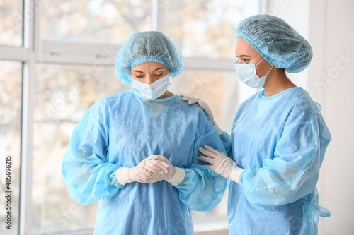 Female surgeon calming her ...