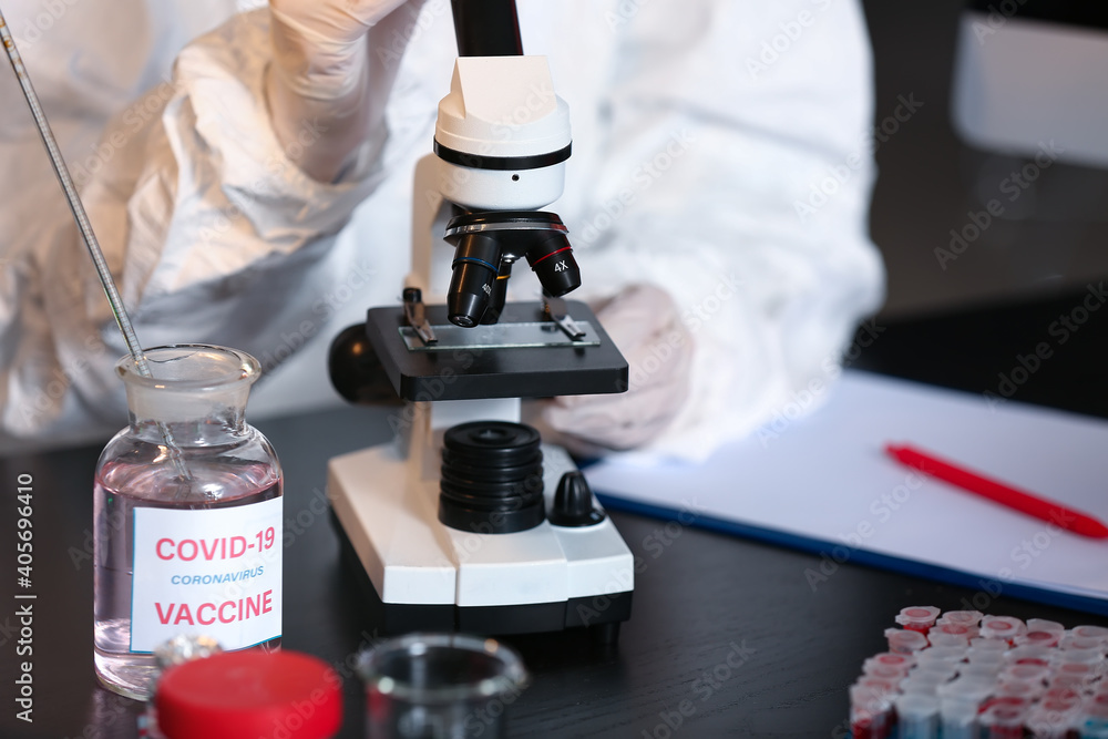 Scientist developing covid-19 vaccine in laboratory Scientist developing covid-19 vaccine in laboratory