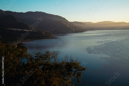 Sunrise at Lake Atitlán surrounded by mountains - sunrise landscape at lake in Guatemala