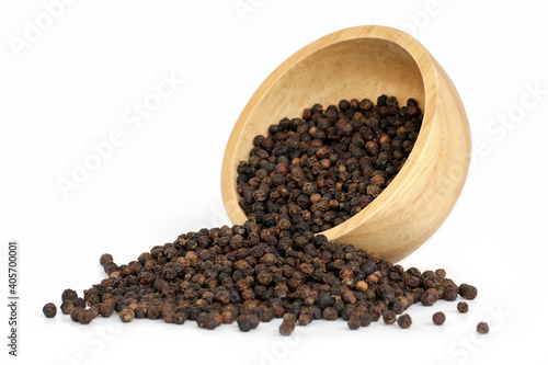Black pepper (Black peppercorns) in wooden bowl isolated on white background.